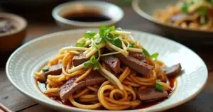 A plate of Chow Ho Fun with stir-fried wide rice noodles, beef slices, bean sprouts, and scallions, served on a white ceramic plate with chopsticks on the side.
